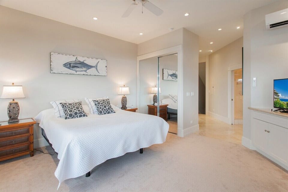 This serene sanctuary features plush carpeting, a California King bed with a new Sealy mattress, a spacious dresser with drawers, a flat-screen TV, the added luxury of split air conditioning and a private lanai