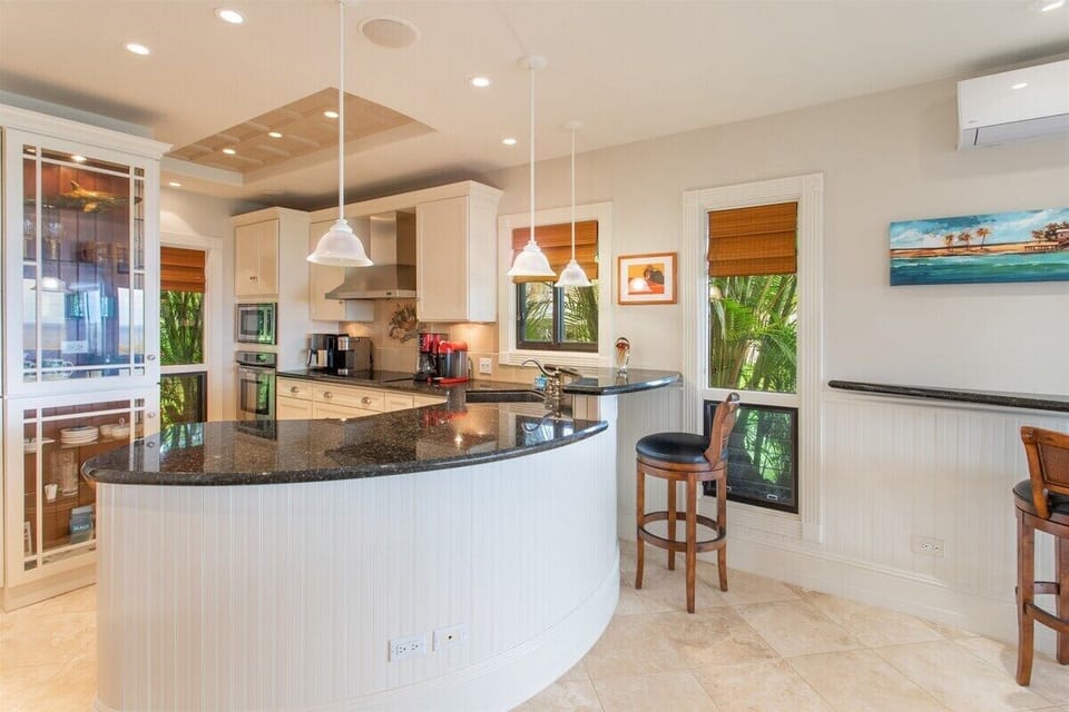The remodeled chefs kitchen sits adjacent to the living room