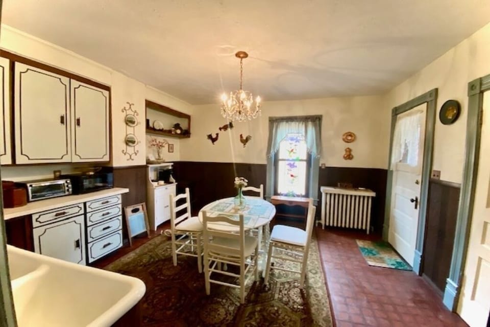 Kitchen w/ door leading to outdoor patio.