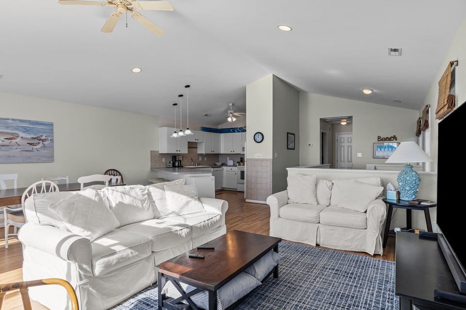 Relax in your bright, open living space with coastal charm and modern comfort for the perfect beach getaway.