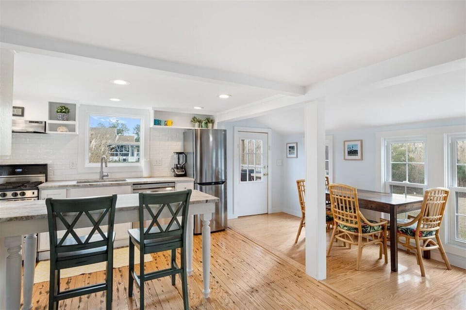 Dining Area opens to Well-Stocked Kitchen with Breakfast Bar.