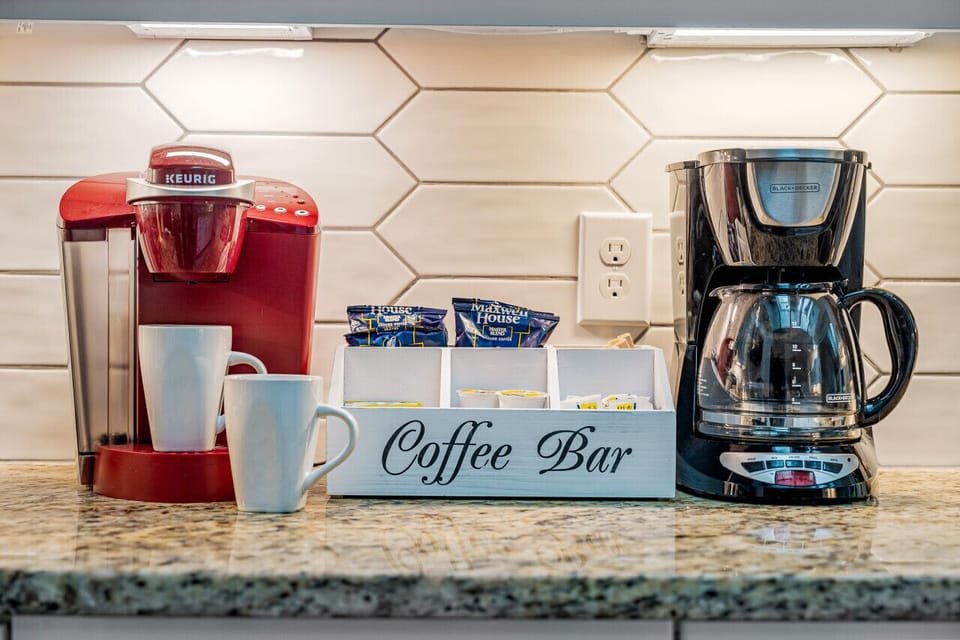 Start your day right with a brew from our deluxe coffee station, equipped with a Keurig and a traditional coffee maker. Your perfect cup awaits, complete with sugar and other essentials.