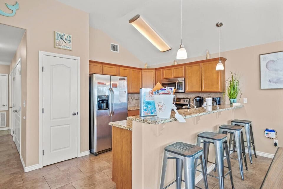 Spacious kitchen with bar seating and open layout.