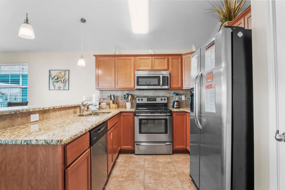 Kitchen with granite countertops and stainless steel appliances.