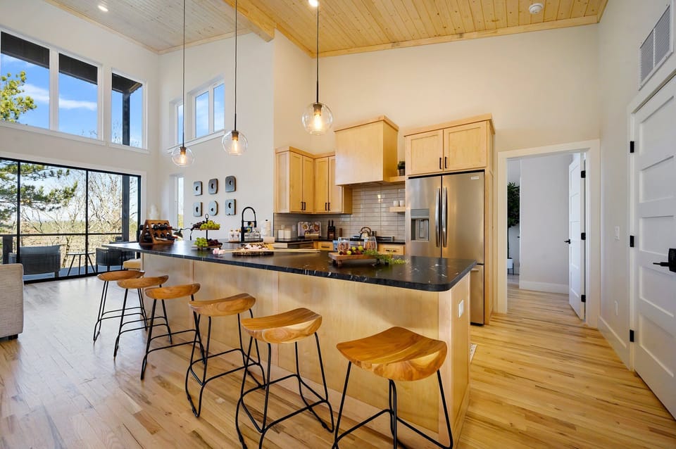 Gourmet Kitchen: Bright and airy kitchen with stunning views and stylish seating for unforgettable meals!