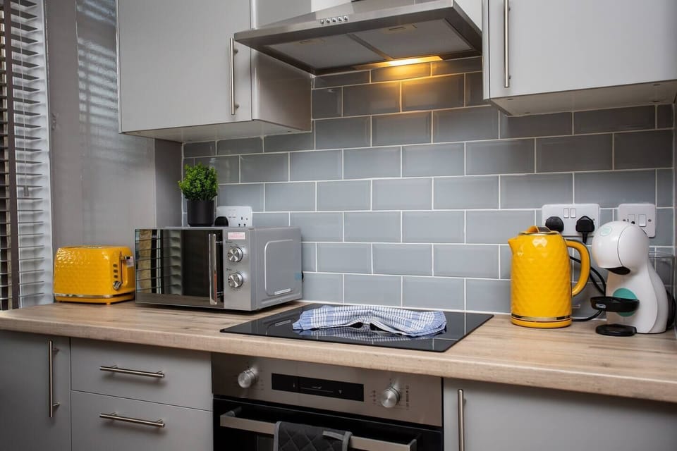 Equipped with all the essentials, including ample cabinet space, coffee facilities, microwave, sink, and a cooker, this space is a haven for culinary enthusiasts.