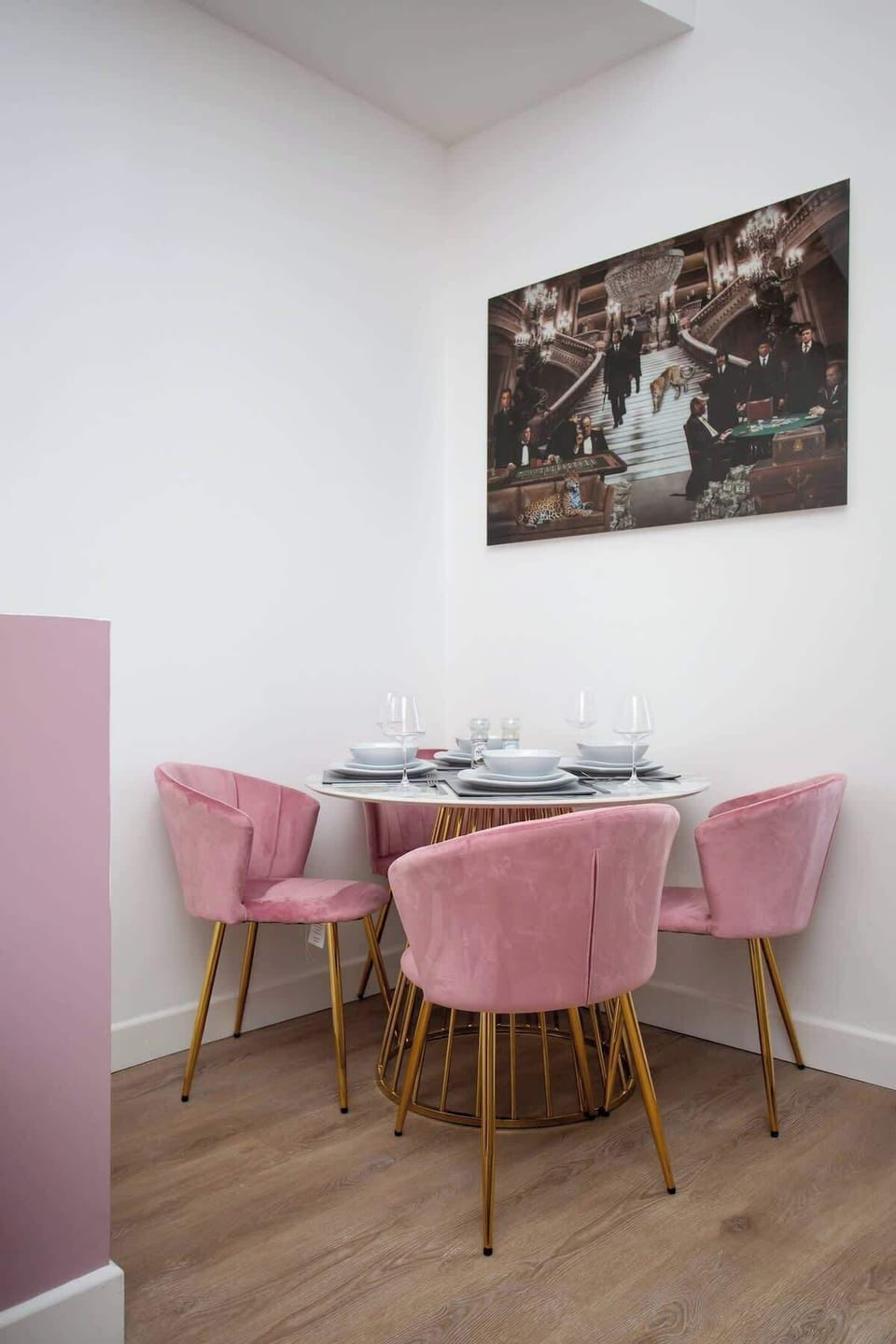  Gather with loved ones in the inviting dining area, where a sleek table for four awaits beneath the soft glow of lighting. 