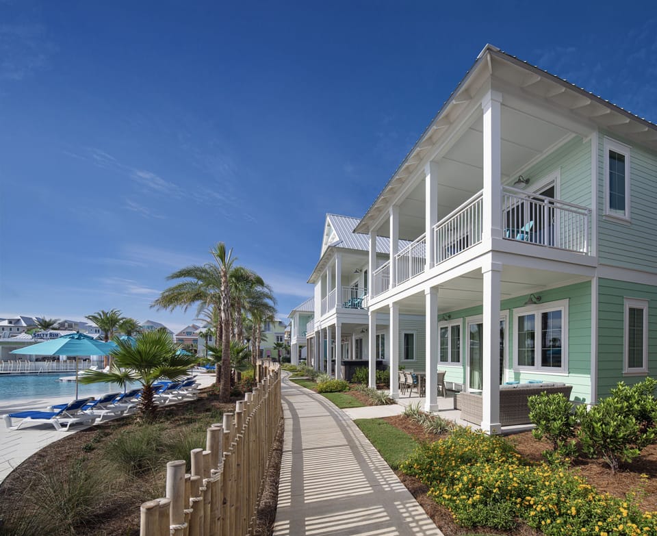 Stroll along sunlit walkways framed by swaying palms and endless ocean skies, steps from the shoreline.