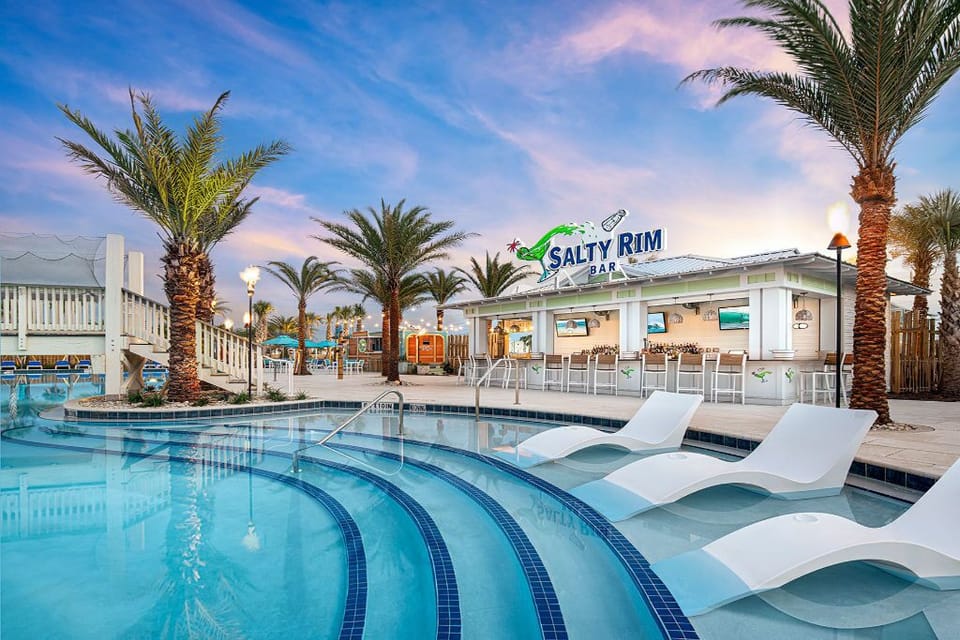 Sip your favorite drink at the bar, just steps from the sparkling water and glistening sun.
