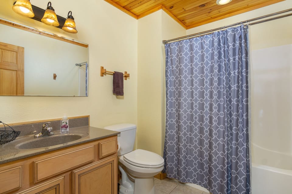 Upper-level bathroom, with bathtub and shower combination, accessed from the hallway