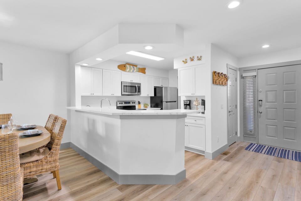 Fully stocked kitchen with stainless steel appliances.