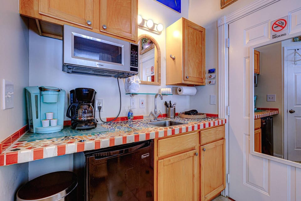 The convenient kitchenette is nicely equipped, offering a perfect spot for preparing quick meals or getting ready for a fun day in Key West.