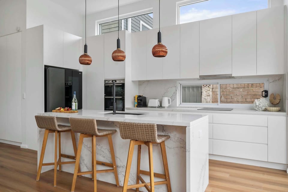 Sleek and contemporary kitchen with a stylish counter, perfect for casual dining or entertaining in effortless style.