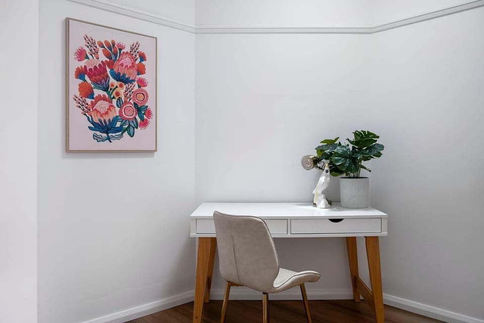 Thoughtfully designed workspace, perfect for productivity, featuring a sleek desk, comfortable seating, and ample natural light.