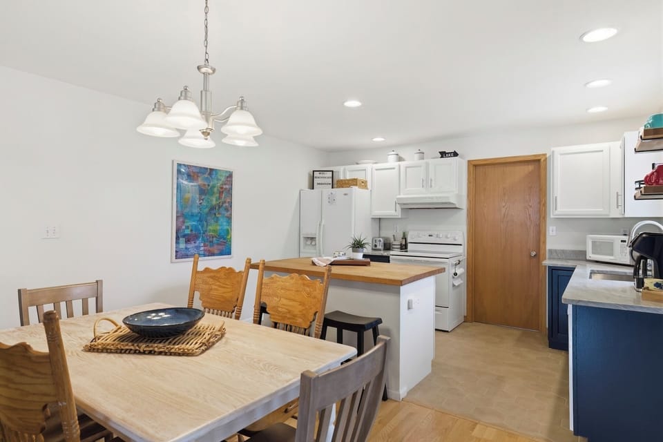 This bright, updated kitchen features white cabinetry and new quartz countertops
