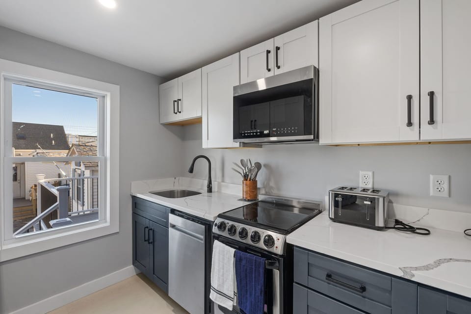 Kitchen also has plenty of cabinets and a dishwasher.