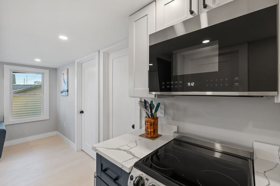 Kitchen with coffee maker, toaster, and all standard appliances, including dishwasher.