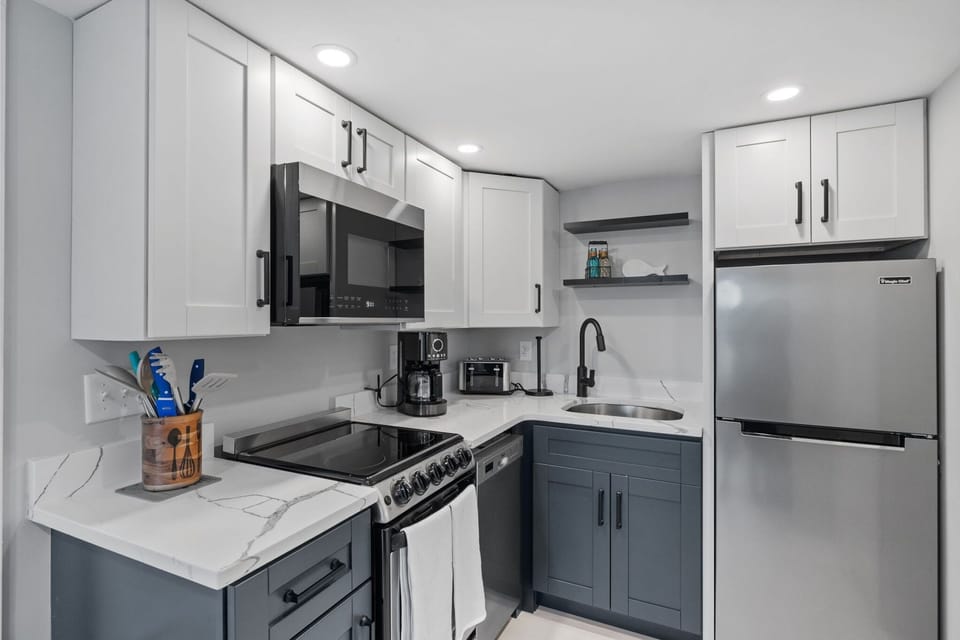 Kitchen with coffee maker, toaster, and all standard appliances, including dishwasher.