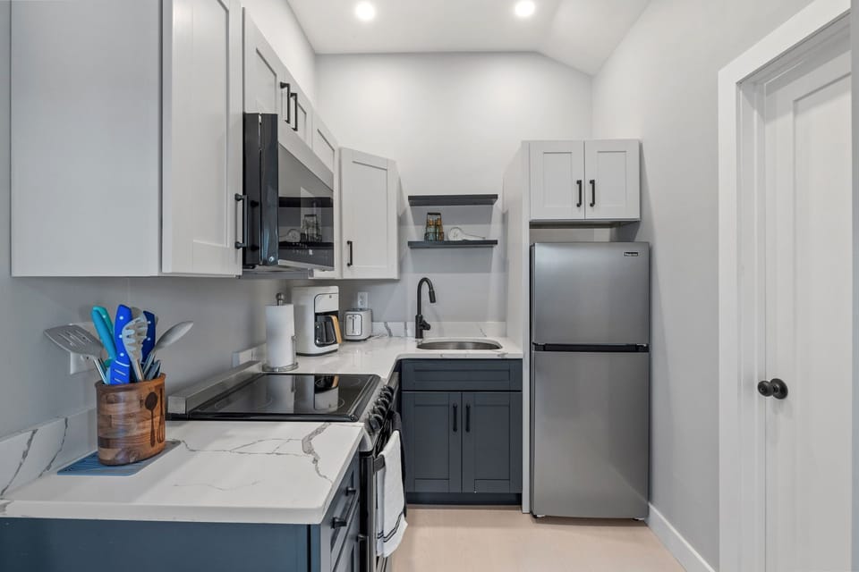 Kitchen with coffee maker, toaster, and all standard appliances, including dishwasher.