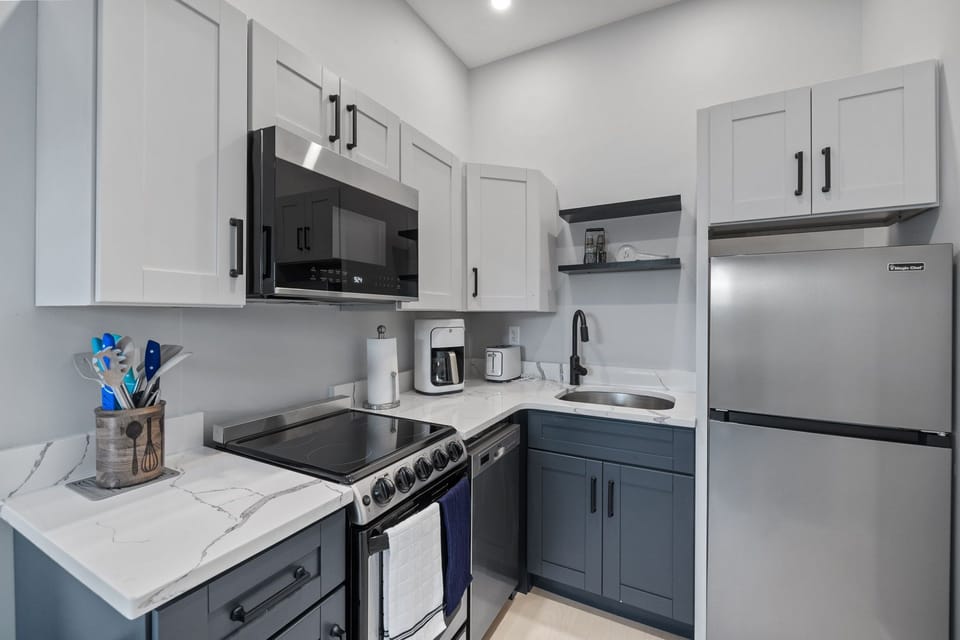 Kitchen with coffee maker, toaster, and all standard appliances, including dishwasher.