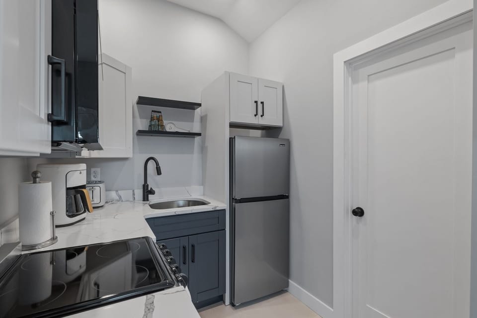 Kitchen with coffee maker, toaster, and all standard appliances, including dishwasher.