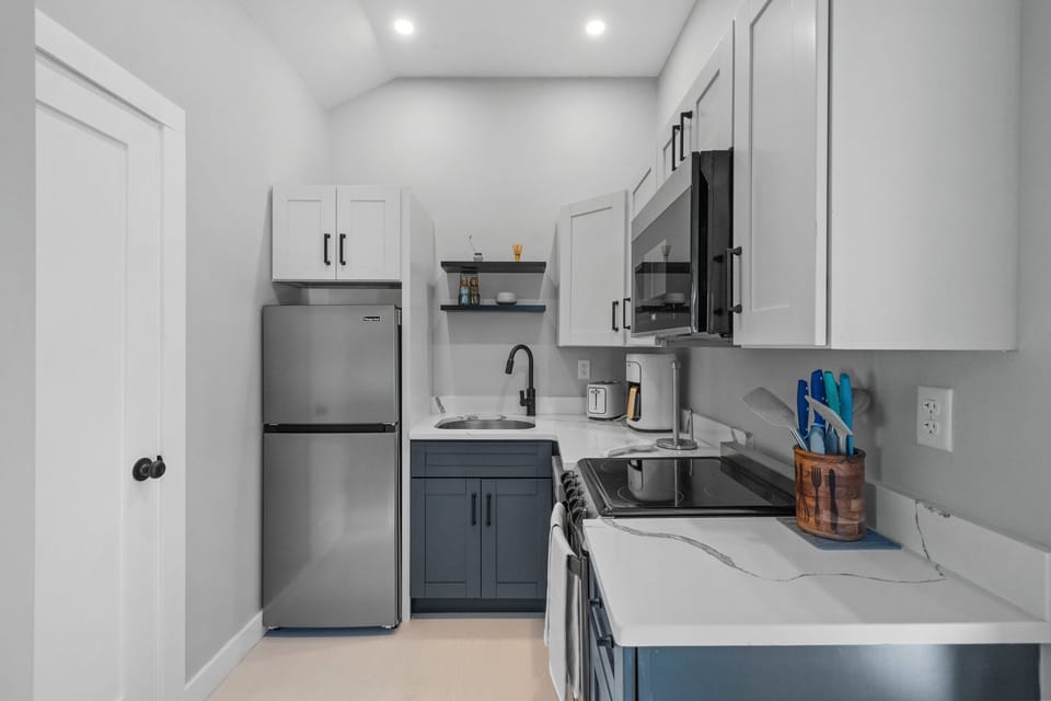 Kitchen with coffee maker, toaster, and all standard appliances, including dishwasher.