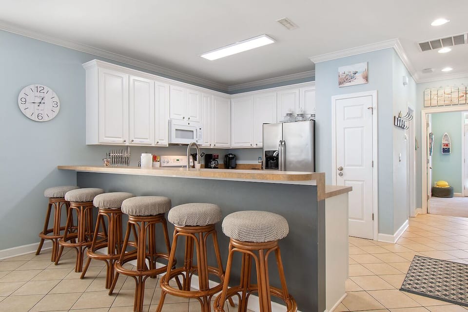 Your spacious kitchen invites casual dining at the breakfast bar, where six stools make family meals memorable.