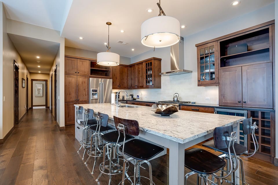 Your gourmet kitchen features granite counters, stainless steel appliances, and a spacious island perfect for gathering with loved ones.