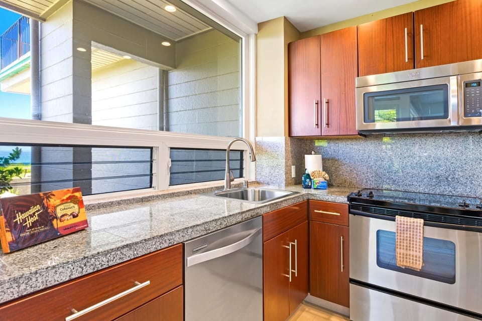 Cook with ease in this fully equipped kitchen featuring sleek appliances and granite counters