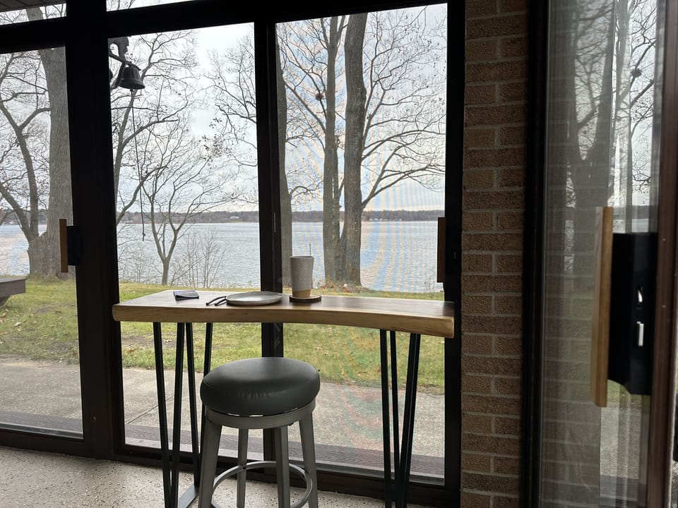 Morning coffee in 3 seasons porch overlooking White Lake.