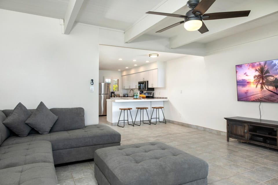 Natural wood tones, coastal textiles, and clean lines make this space feel effortlessly relaxed and family-ready   