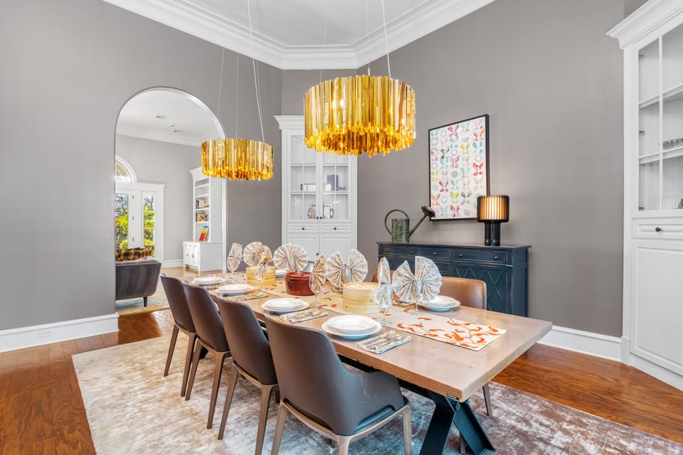 Gather beneath striking crystal chandeliers that cast a warm glow over the polished table—perfect for celebratory dinners or lingering conversations late into the evening.