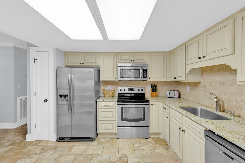 Fully stocked kitchen with stainless steel appliances