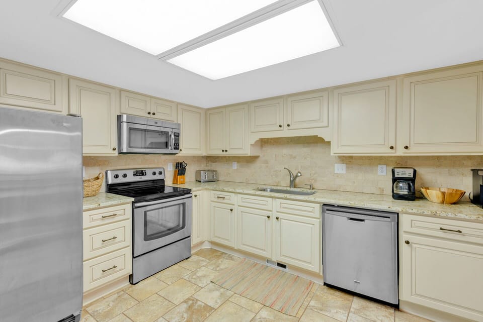 Fully stocked kitchen with stainless steel appliances