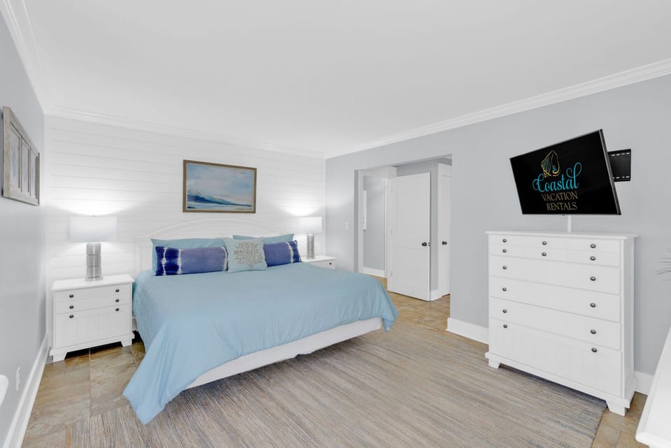 Bedroom 1 - king bed with a tv and a ensuite bathroom