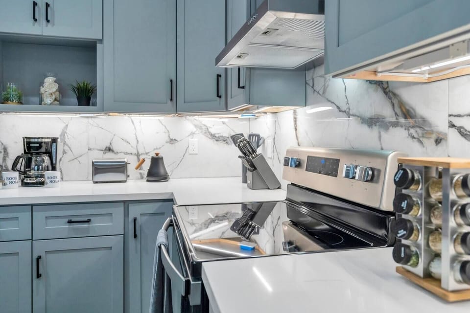 Kitchen w/ stainless steel appliances & ample counter space for home-cooked meals.
