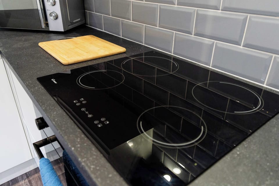 Fuel up before heading out from this spacious, well-lit kitchen, equipped for everything from morning coffee to quick meals. The open layout and generous workspace make preparing food simple, convenient and comfortable during your stay.