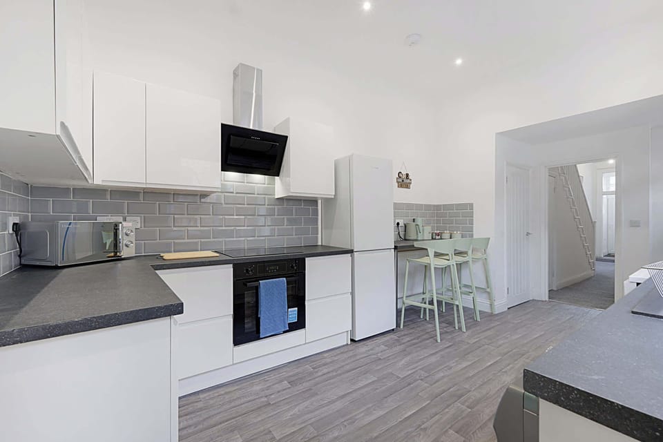 Fuel up before heading out from this spacious, well-lit kitchen, equipped for everything from morning coffee to quick meals. The open layout and generous workspace make preparing food simple, convenient and comfortable during your stay.