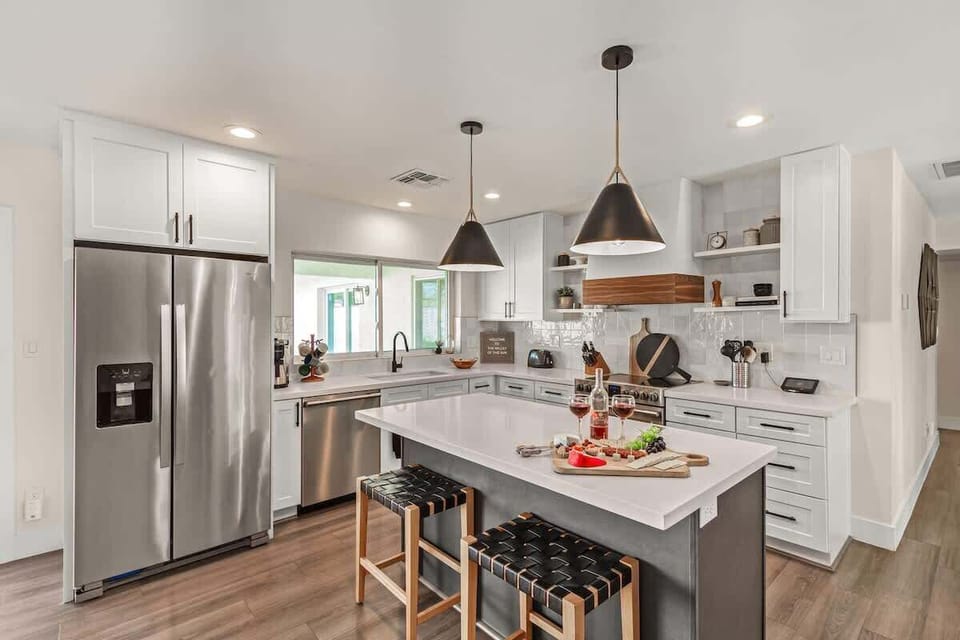 Fully equipped kitchen stocked with your basic cooking essentials, stainless steel appliances, and bar seating.