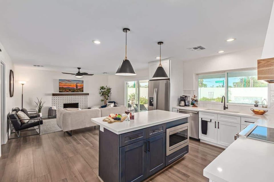 Fully equipped kitchen stocked with your basic cooking essentials, stainless steel appliances, and bar seating.