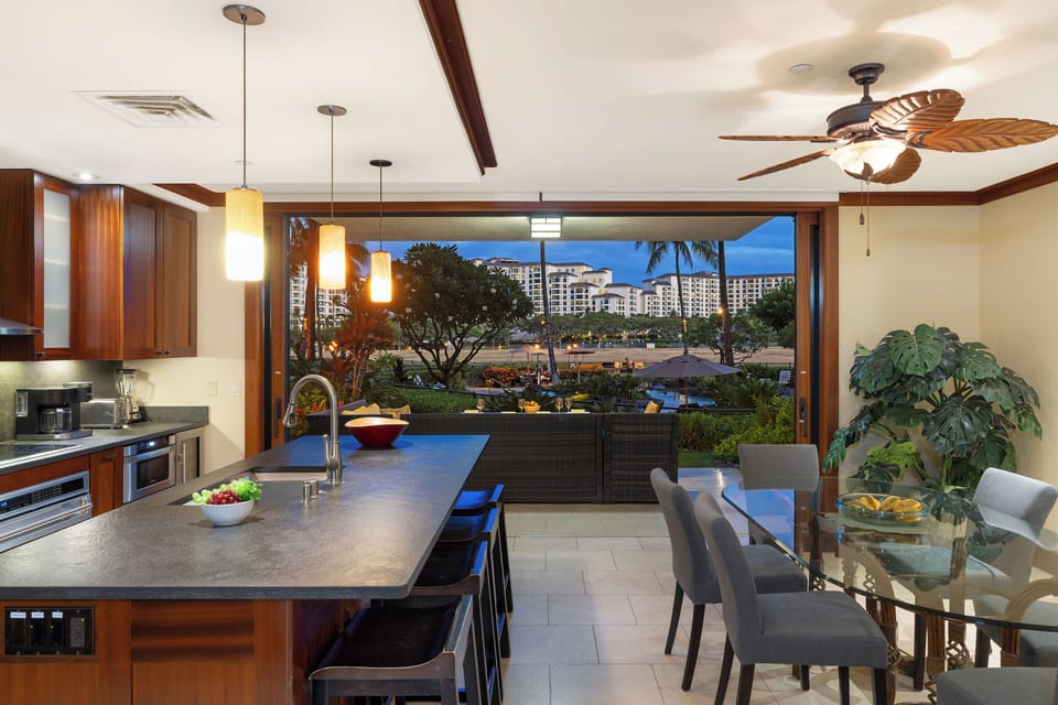 Seamless flow from the kitchen to the adjacent dining area with table for six.