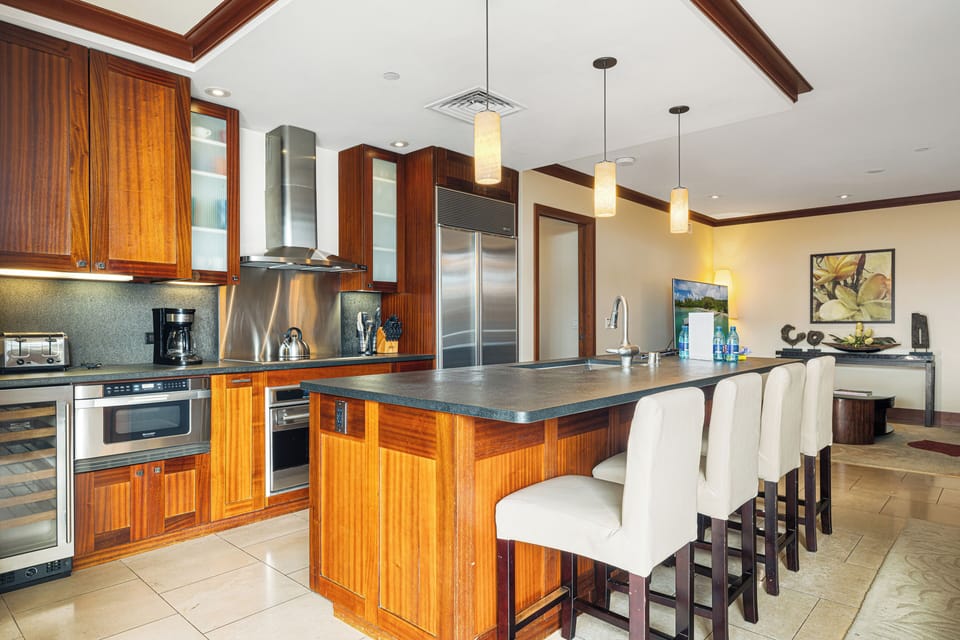 Your gourmet kitchen invites culinary adventures with rich wood cabinetry, sleek granite counters, and top-tier stainless steel appliances. Gather at the spacious island for meals and memories together.