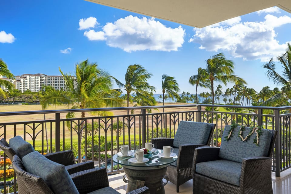 Sip your morning coffee from this stunning balcony overlooking swaying palms and pristine coastline.