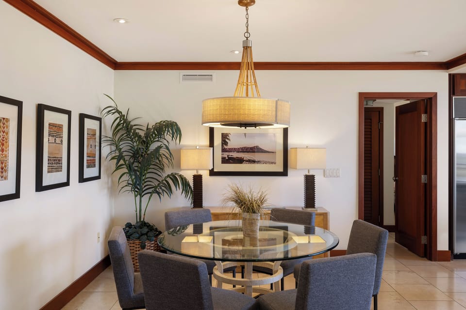 Gather around your elegant glass dining table where modern design meets warm wood accents for memorable meals together.