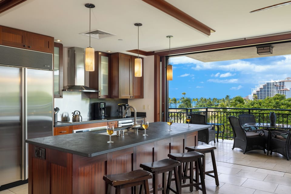Cook in your gourmet kitchen while enjoying tropical views through floor-to-ceiling windows that open to your private balcony.
