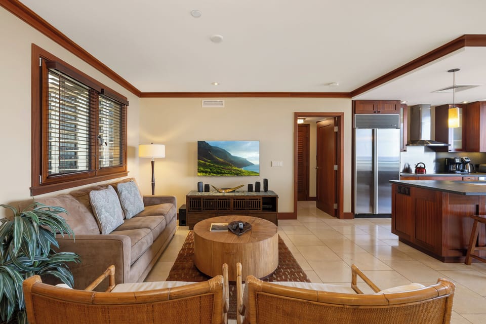 Sink into plush seating and enjoy your spacious open-concept retreat with modern kitchen and warm tropical touches.