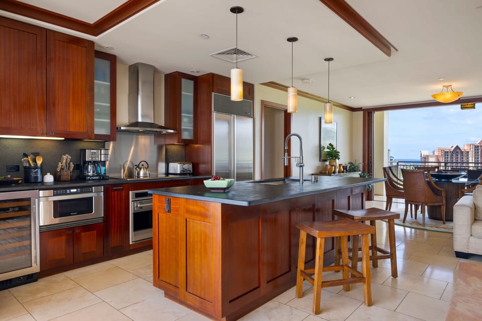 Your gourmet kitchen awaits with rich wood cabinets, granite counters, and stunning city views through floor-to-ceiling windows.