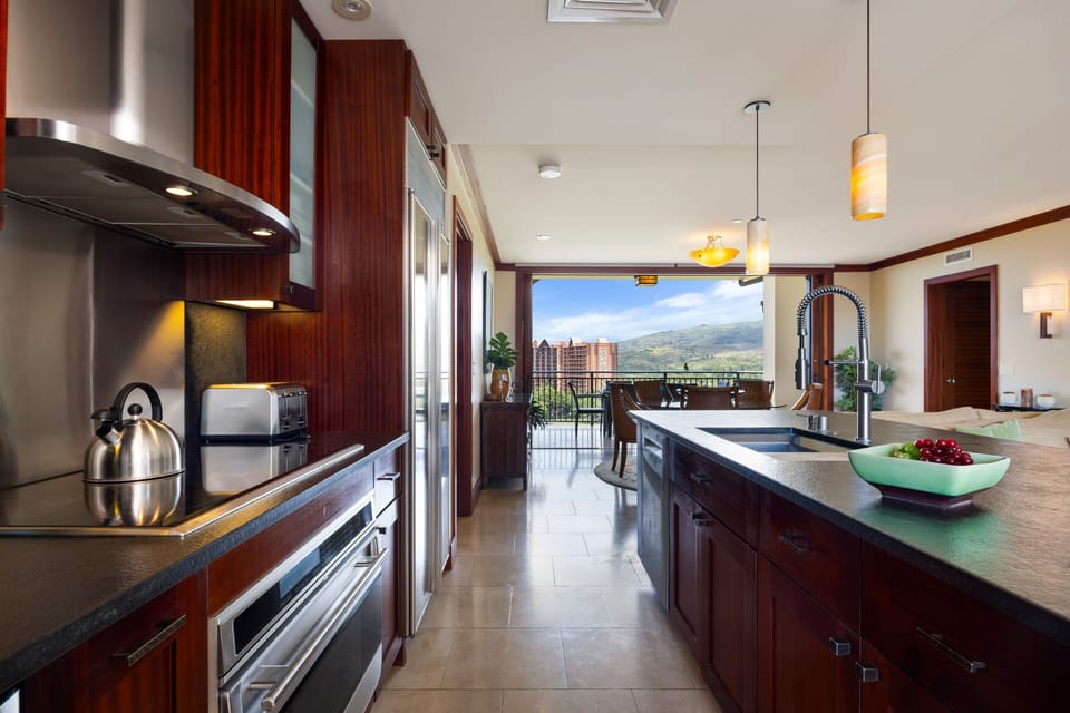Cook with stunning mountain views from your gourmet kitchen, featuring rich mahogany cabinets, granite counters, and premium stainless appliances.