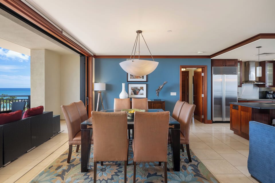 Gather around your elegant dining table with ocean views, where memorable meals unfold against stunning blue waters.