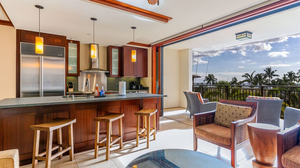 A Roy Yamaguchi-designed kitchen featuring high-end finishes and island views.